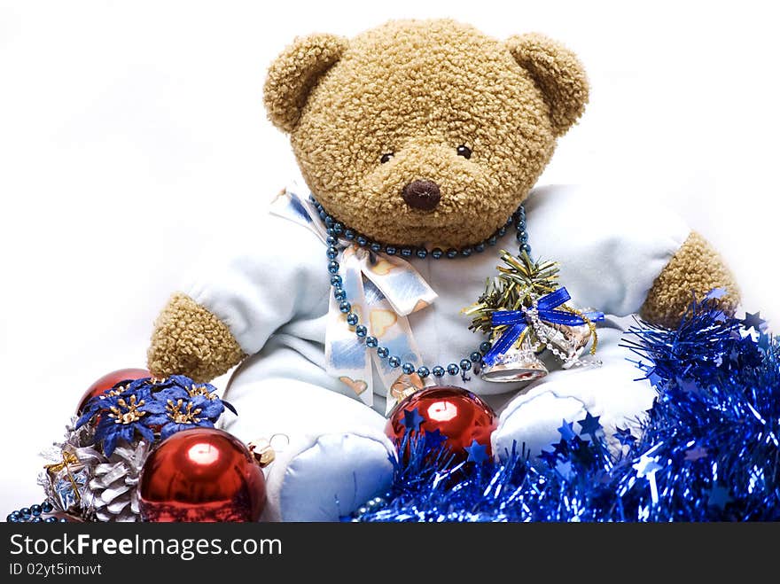 Soft bear with Christmas balls, cone, tinsel, garland and bells. Soft bear with Christmas balls, cone, tinsel, garland and bells