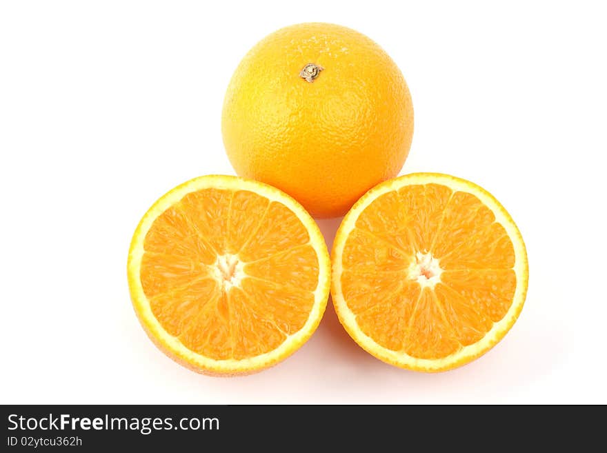 Close up an orange and two half a tablet of orange on a white background. Close up an orange and two half a tablet of orange on a white background