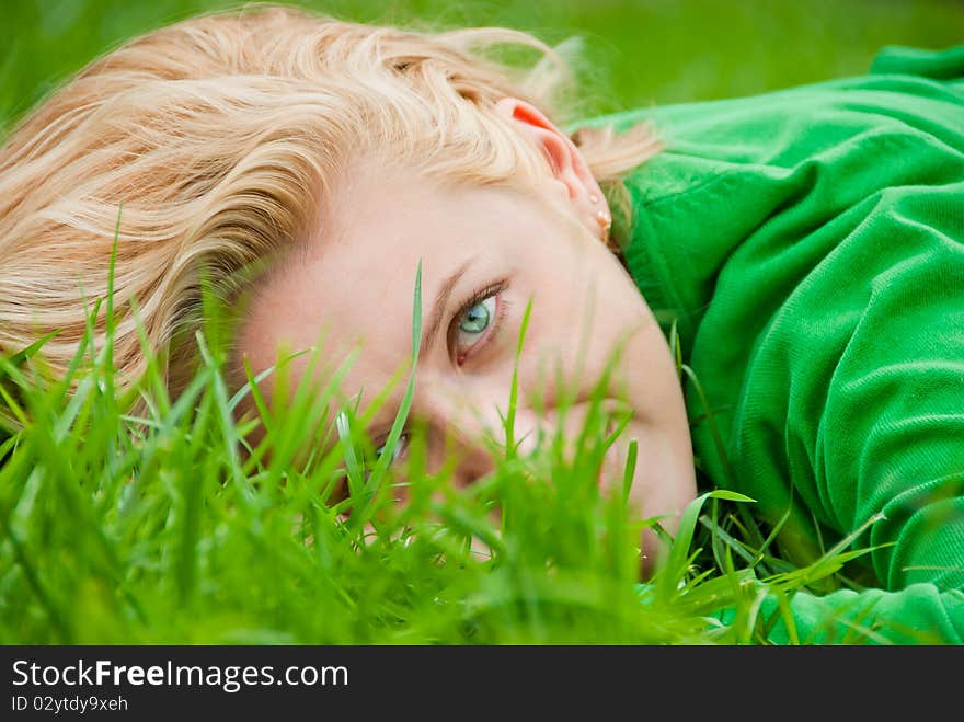 Young Blonde Lying In A Grass