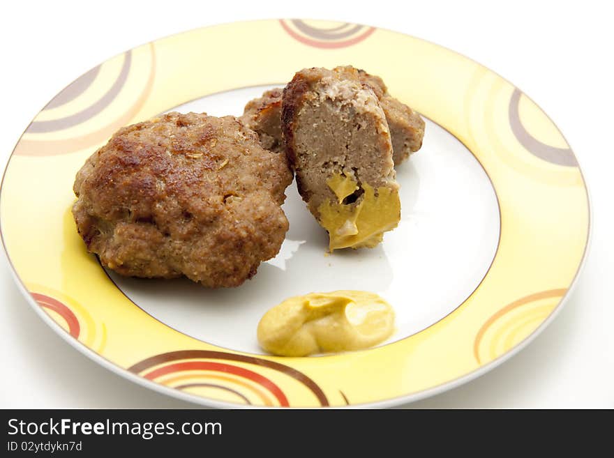 Rissole roasted with mustard and onto plates