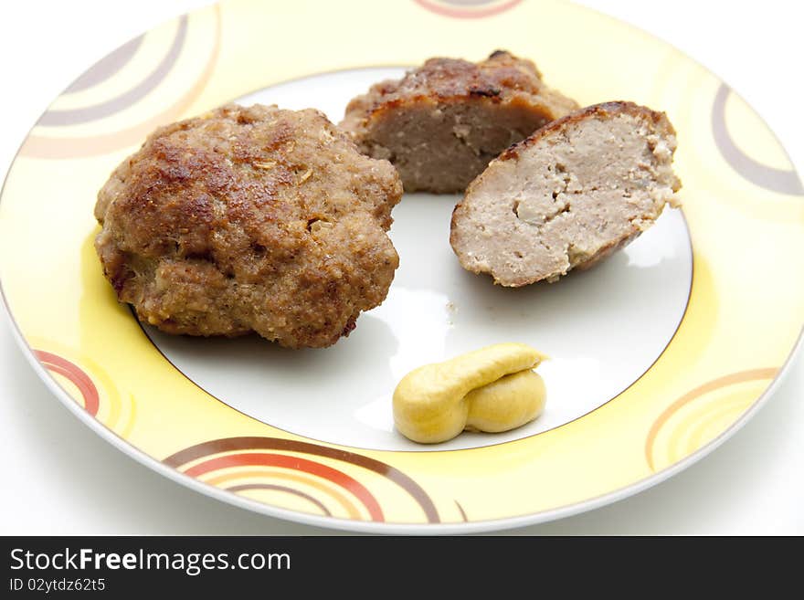 Rissole roasted with mustard and onto plates