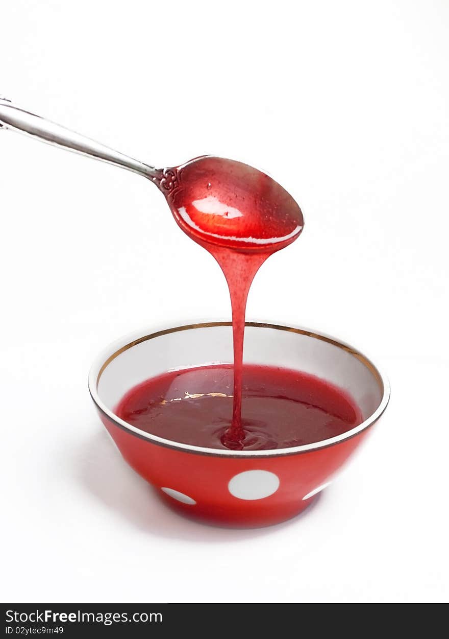 Berry jam in a red saucer (isolated on a white)