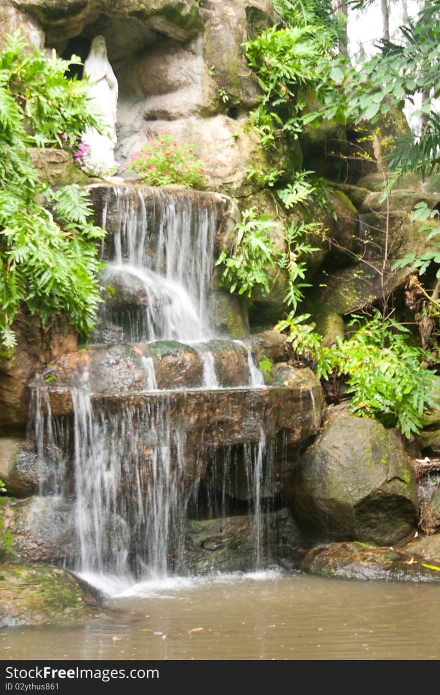 Waterfalls in the park. A statue of the goddess. Of Christianity. Waterfalls in the park. A statue of the goddess. Of Christianity.