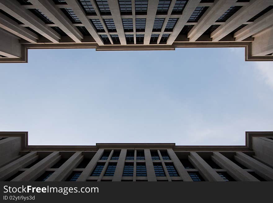 Sky between tall buildings. One corner between two buildings spaced tall buildings to clear skies. Sky between tall buildings. One corner between two buildings spaced tall buildings to clear skies.