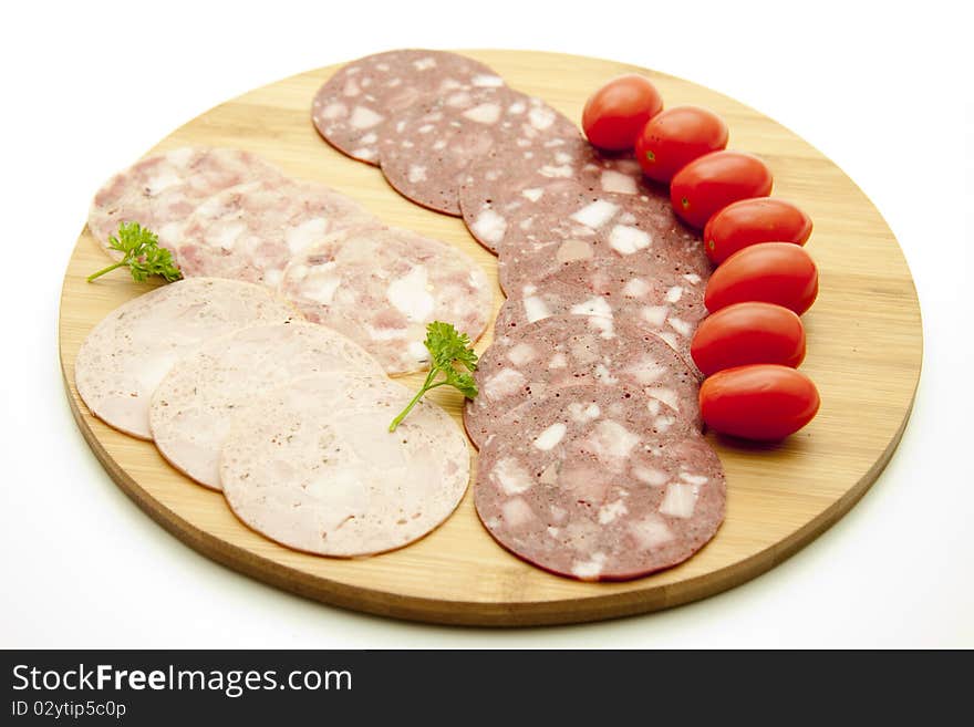 Sausage plate with cherry tomatoes and parsley. Sausage plate with cherry tomatoes and parsley