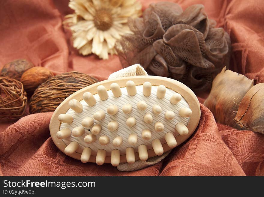 Massage brush with sponge and nut-stale on table cloth
