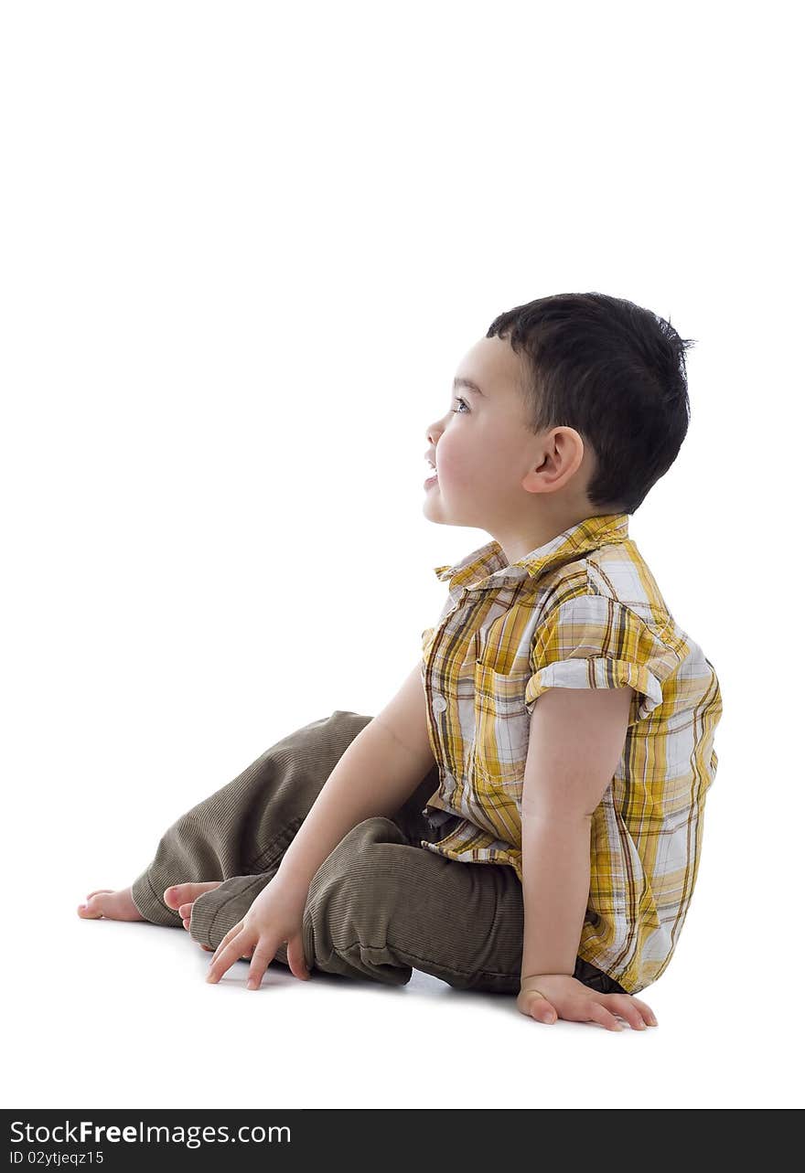 Cute boy sitting and looking to the side, isolate on white background. Cute boy sitting and looking to the side, isolate on white background