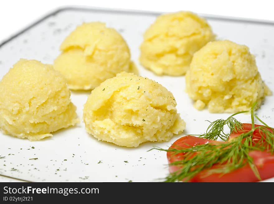 Traditional romanian corn meal (mamaliga) on a white plate. Traditional romanian corn meal (mamaliga) on a white plate