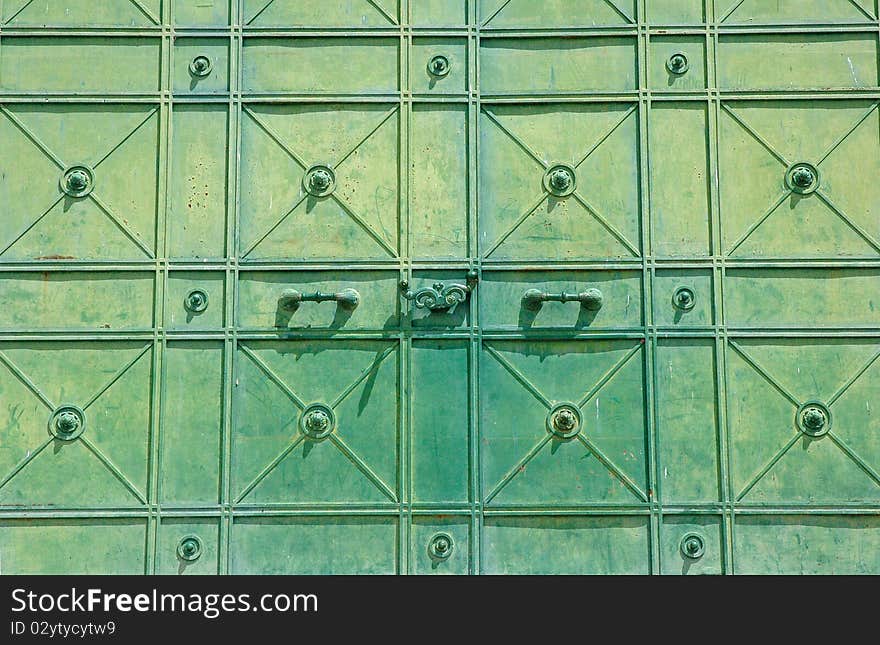 Green rusty metal door detail.