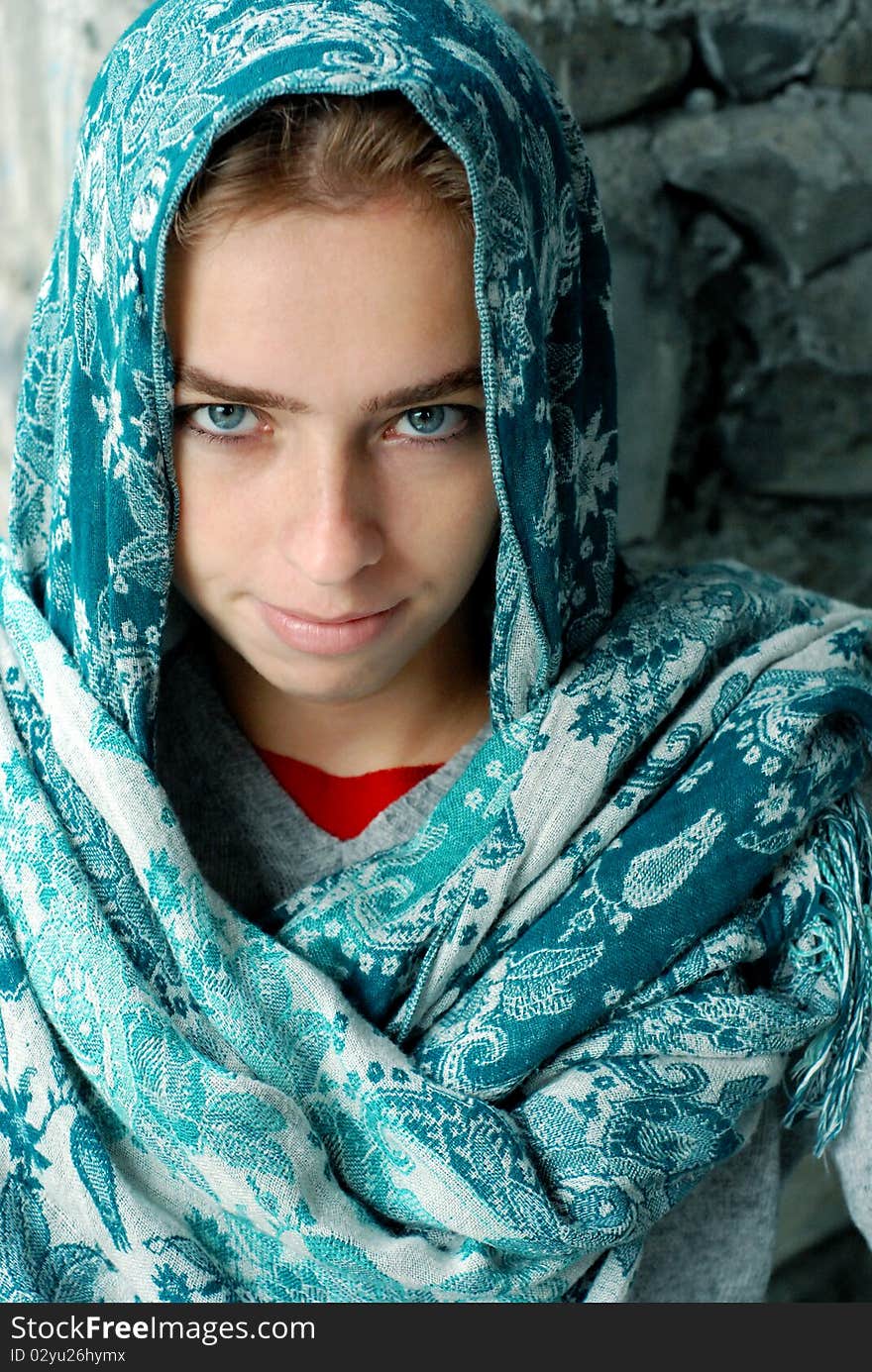 Cute girl in a blue veil smiling