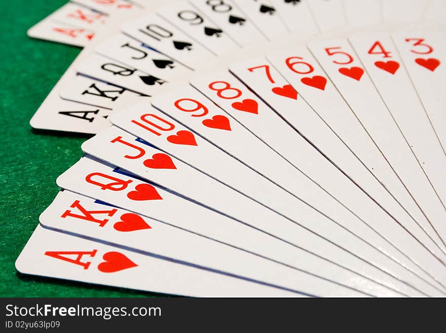 A deck of cards srpead out in a fan shape, with the hearts in focus nearest the camera. A deck of cards srpead out in a fan shape, with the hearts in focus nearest the camera