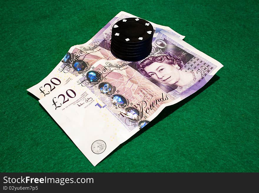 Two English twenty pound notes photographed on a poker table with poker chips. Two English twenty pound notes photographed on a poker table with poker chips