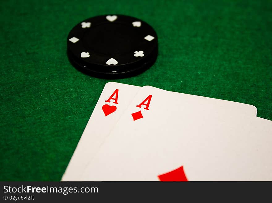 A pair of aces on a poker table with poker chips. A pair of aces on a poker table with poker chips