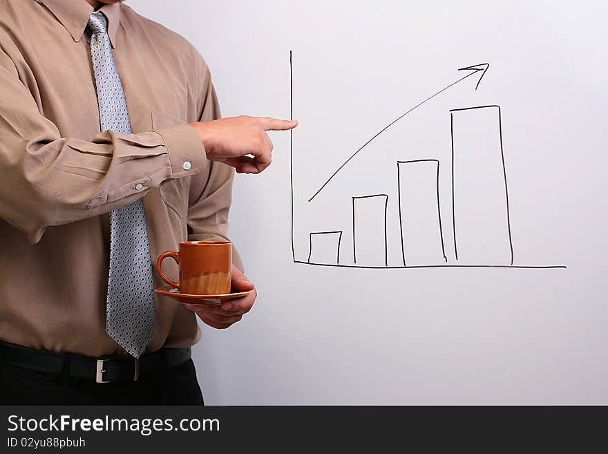 Man in a shirt and a tie holding a plate and a cup while pointing to a drawing of a bar graph. Man in a shirt and a tie holding a plate and a cup while pointing to a drawing of a bar graph.