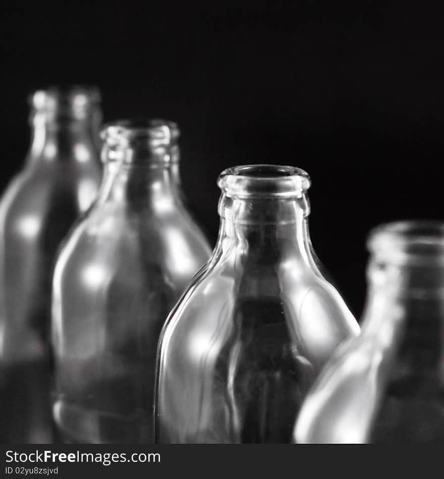 Empty bottles collection, colorless, isolated on black background