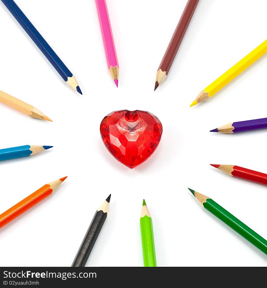 Red crystal heart surrounded with color pencil. Red crystal heart surrounded with color pencil