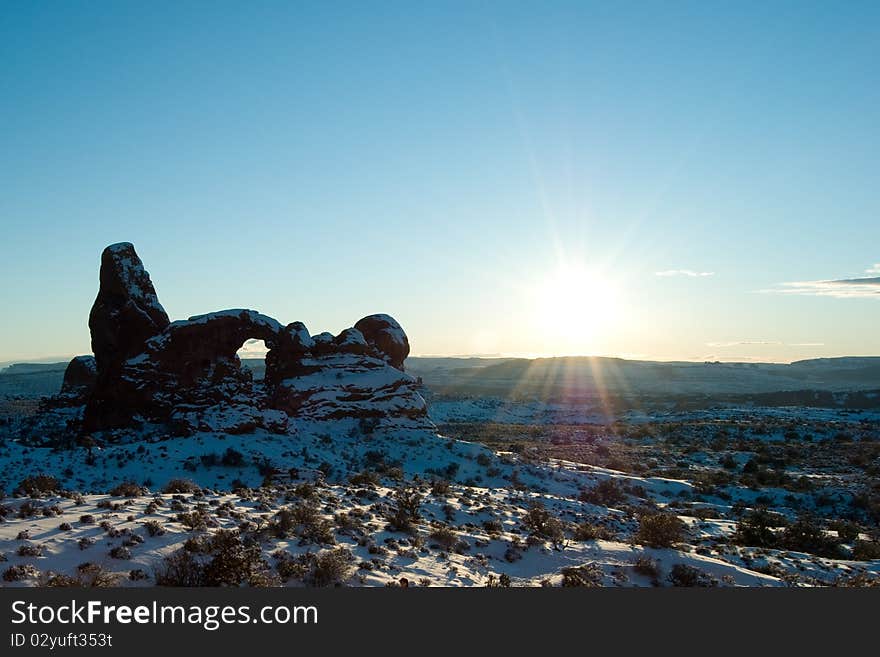 Sun over Turret Arch in Arches National Park