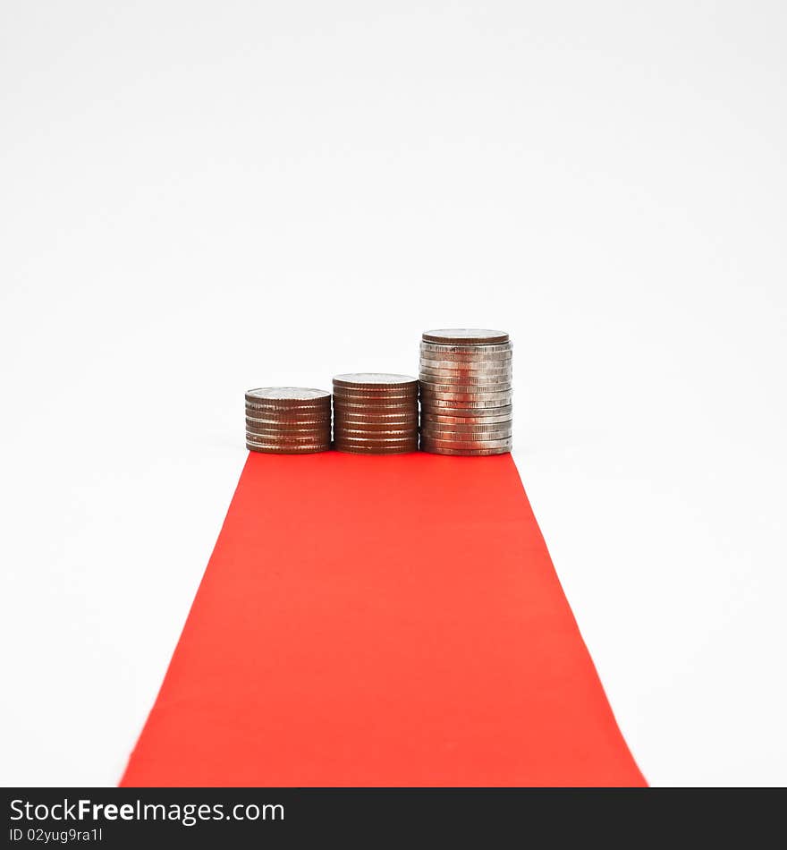 Red carpet and column of coin isolated on white background. Red carpet and column of coin isolated on white background