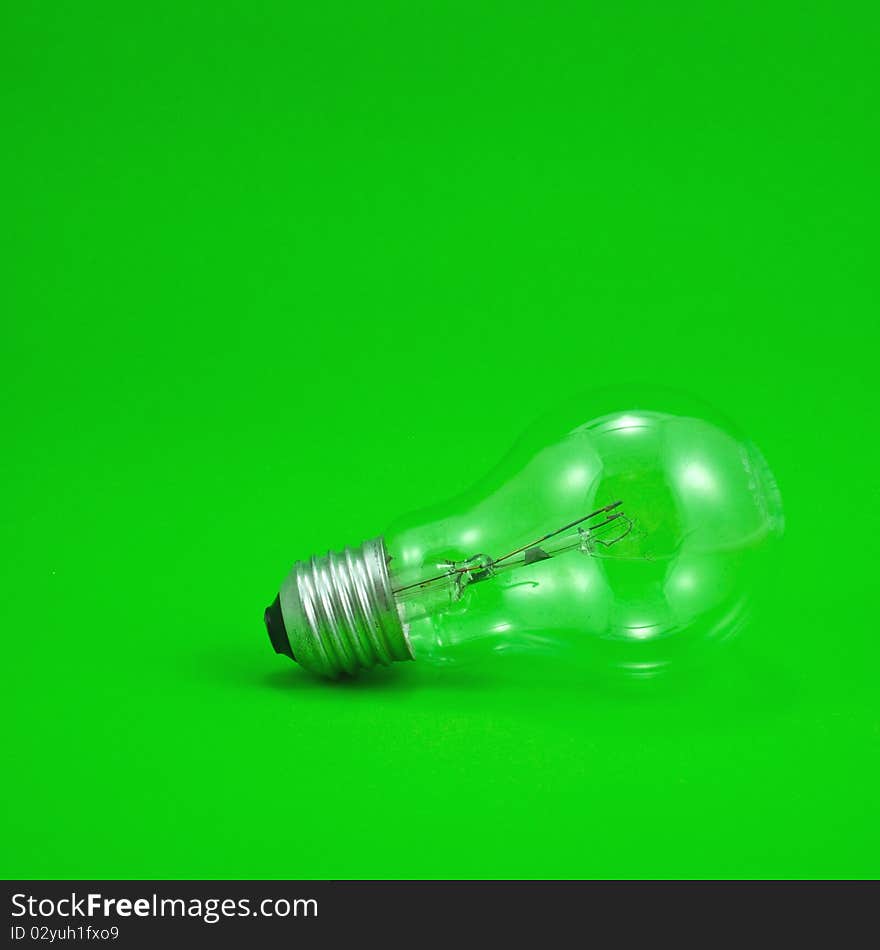 Compact light bulb isolated on green background. Compact light bulb isolated on green background