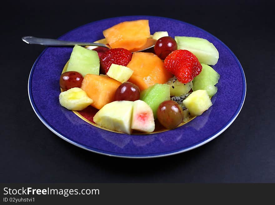 Plate Of Fruit And Spoon.