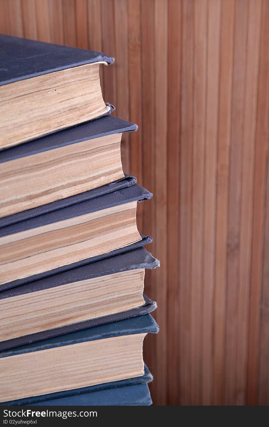 Tower of books with wooden background