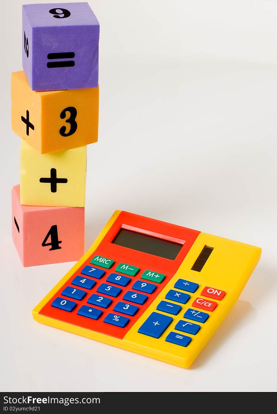 A vertical of a calculator and stacking numbered building blocks. A vertical of a calculator and stacking numbered building blocks