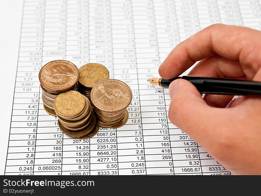 Pen in man's hand on financial document. Studio shot. Pen in man's hand on financial document. Studio shot