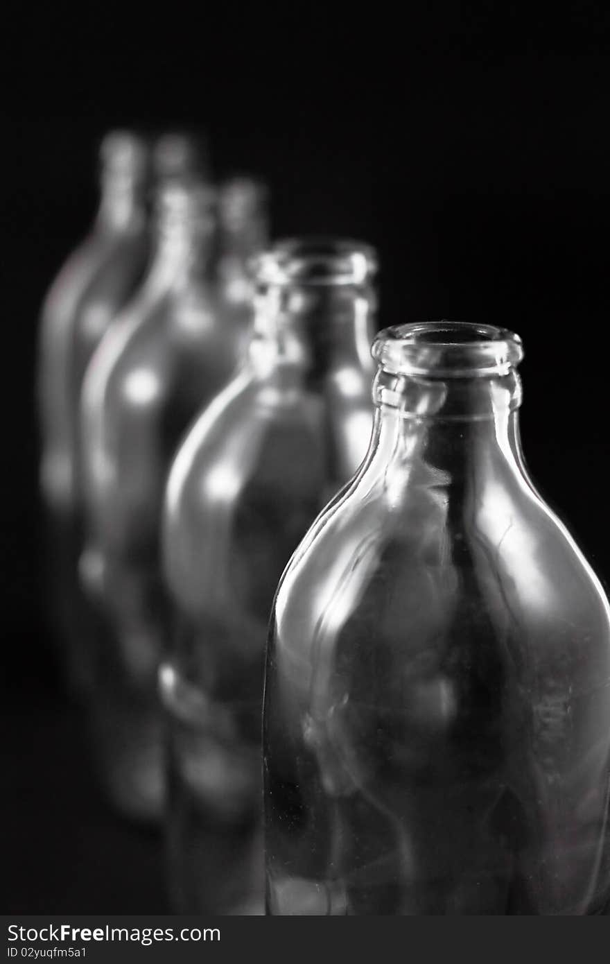 Empty bottles collection, colorless, isolated on black background