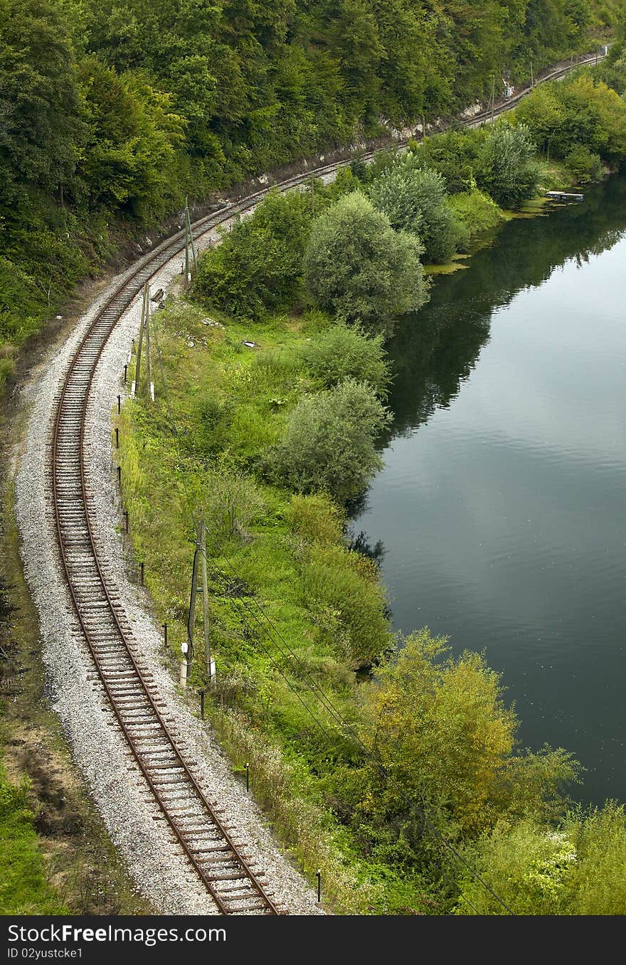 Railroad curve and river with trees. Railroad curve and river with trees