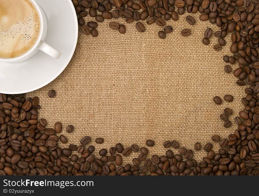 Coffee beans as a frame, and a cup of coffee