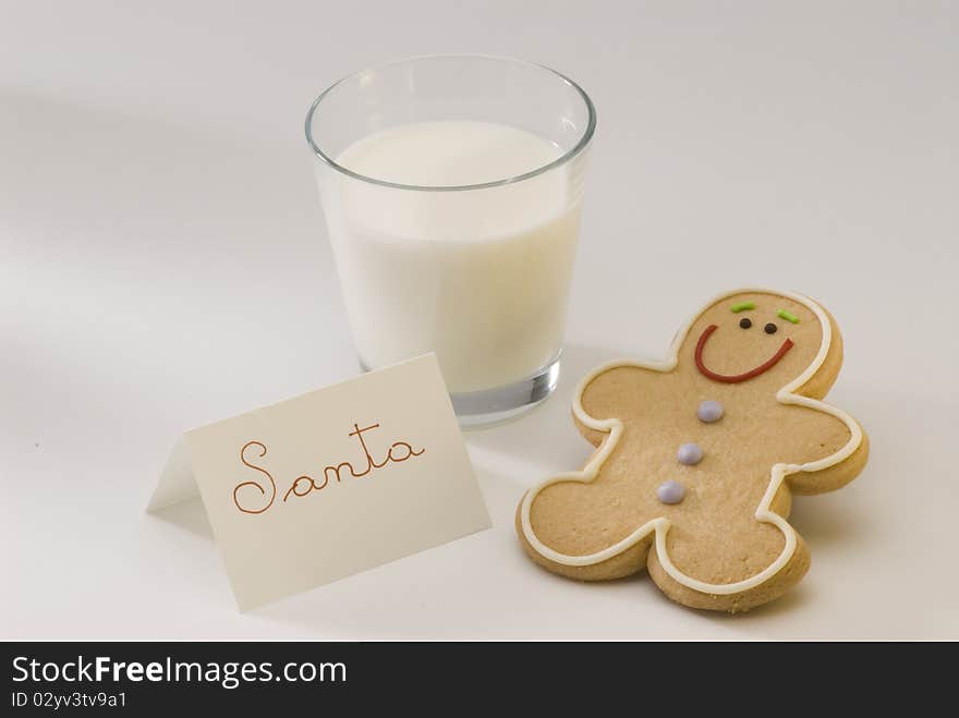 Traditional Christmas gingerbread man cookie and a glass of milk for Santa. Traditional Christmas gingerbread man cookie and a glass of milk for Santa