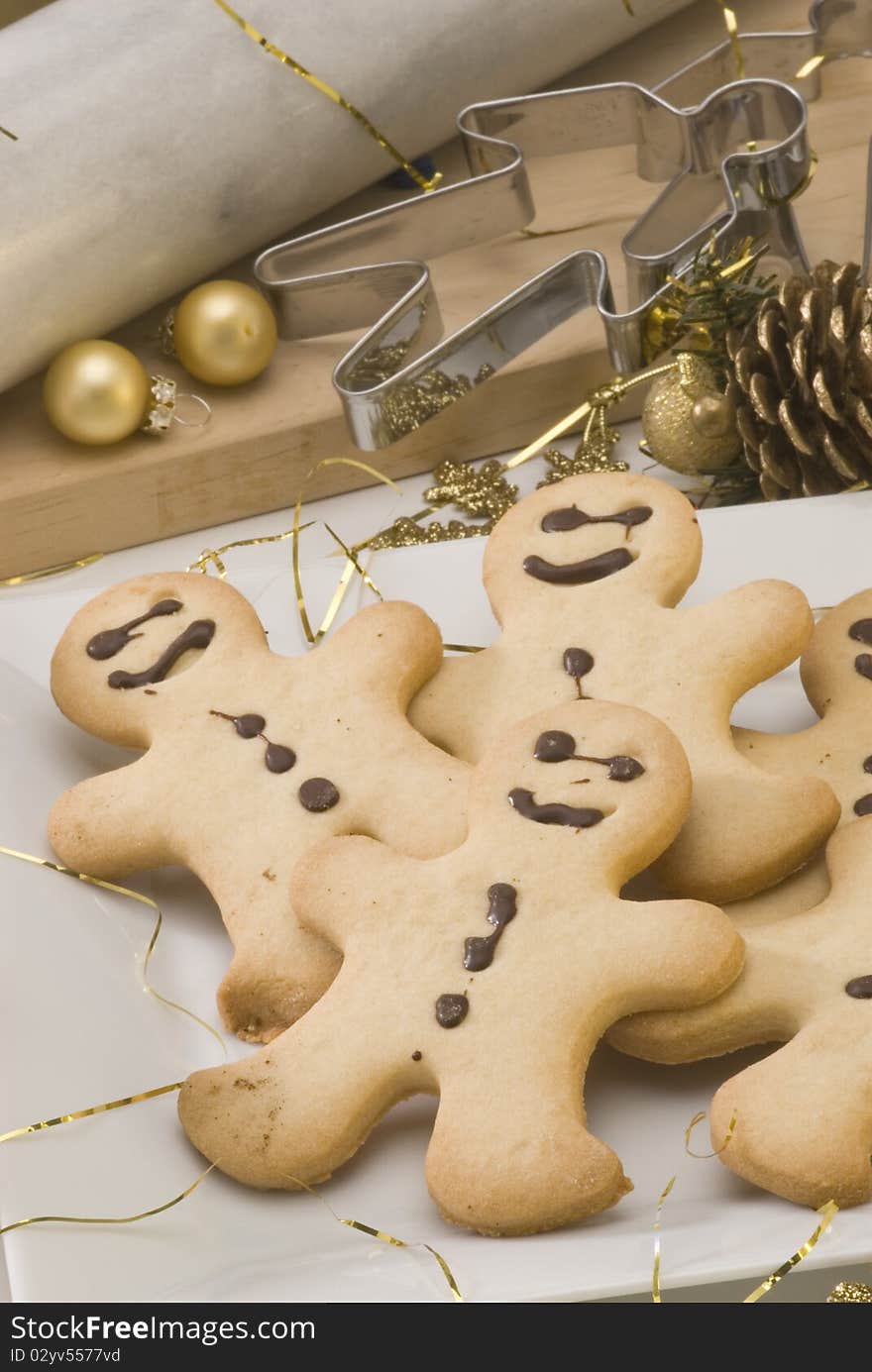 Traditional Christmas gingerbread man cookies in a white plate. Traditional Christmas gingerbread man cookies in a white plate.