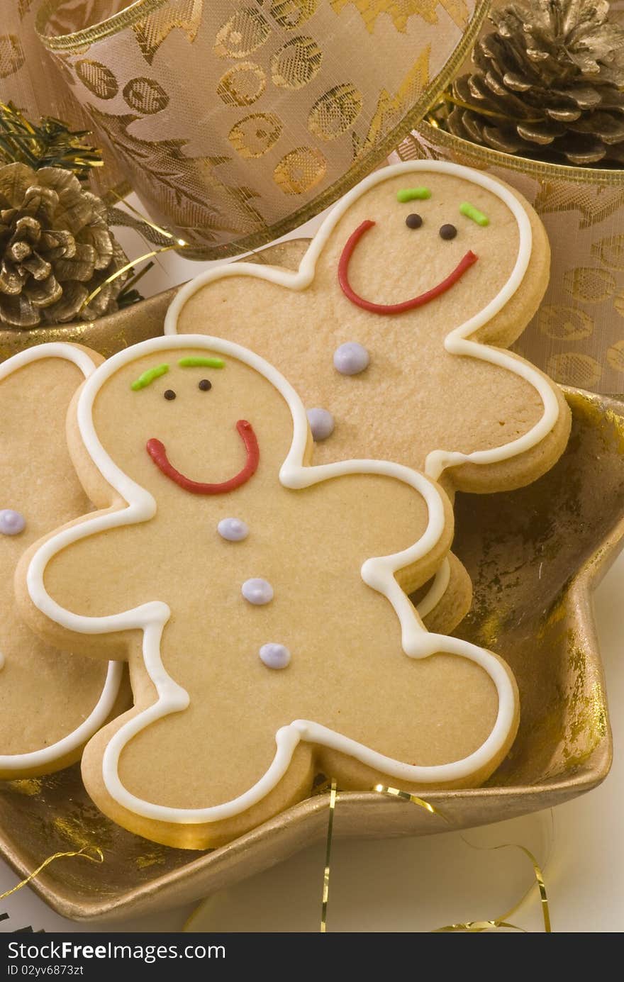 Traditional Christmas gingerbread man cookies in a golden plate. Traditional Christmas gingerbread man cookies in a golden plate.