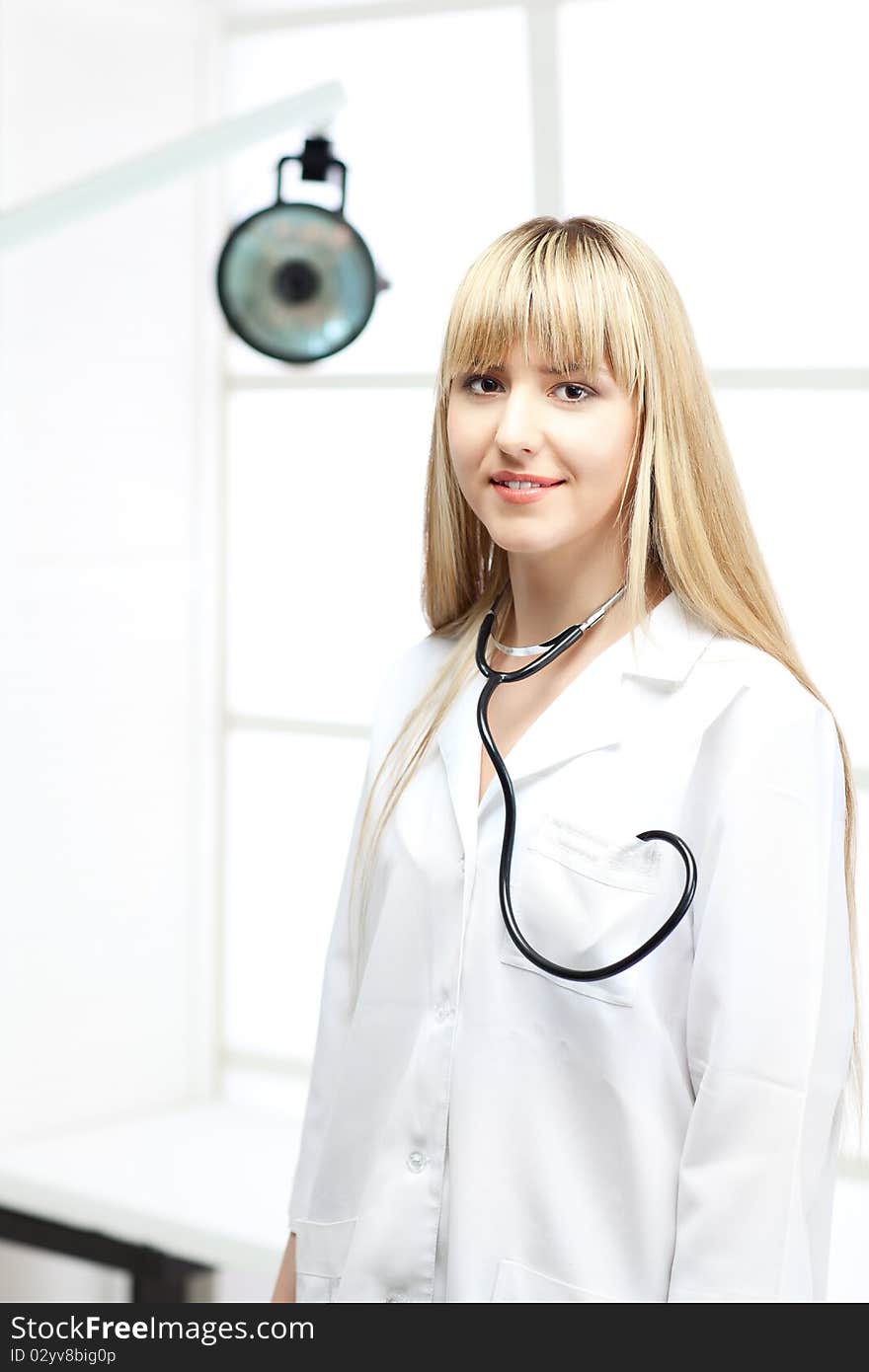 Beautiful woman doctor in uniform over window