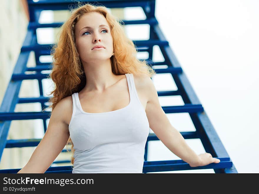 Girl posing over old factory