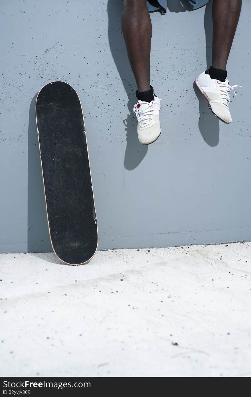 Skateboarder on wall and human legs