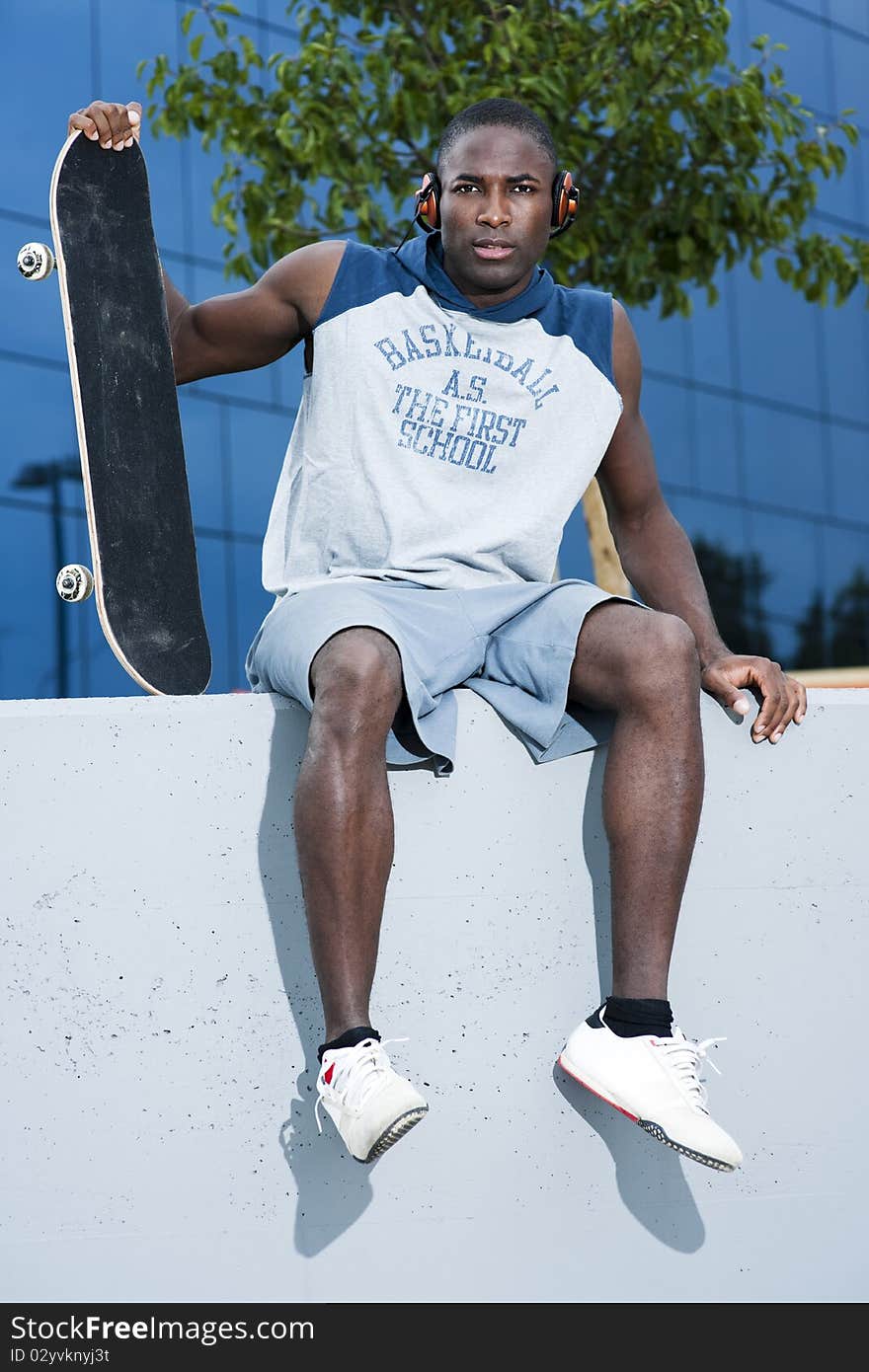 Young skateboarder taking a rest