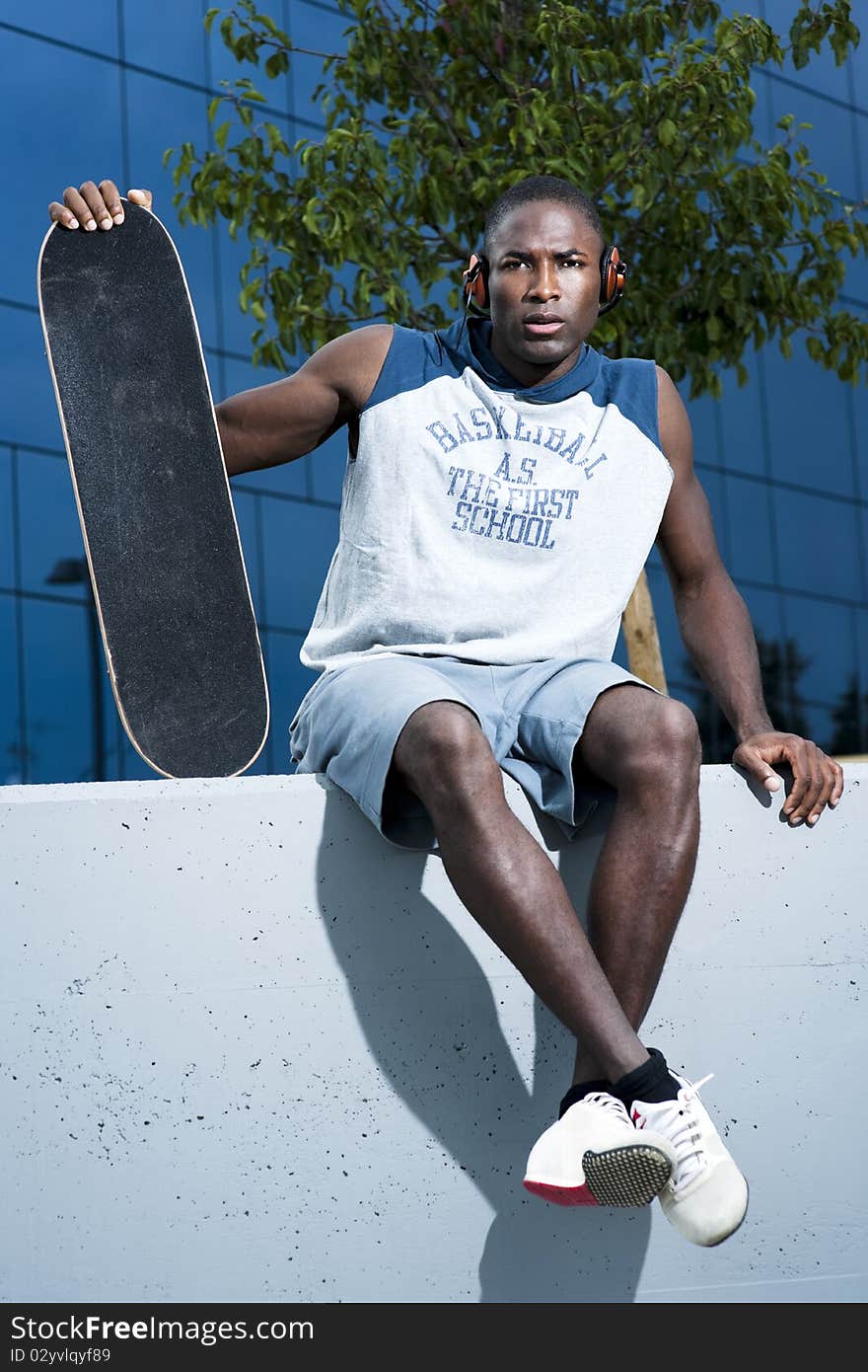 Young skateboarder taking a rest