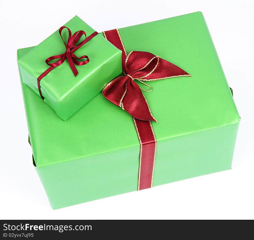 Gifts in green wrapping with red bows on white background