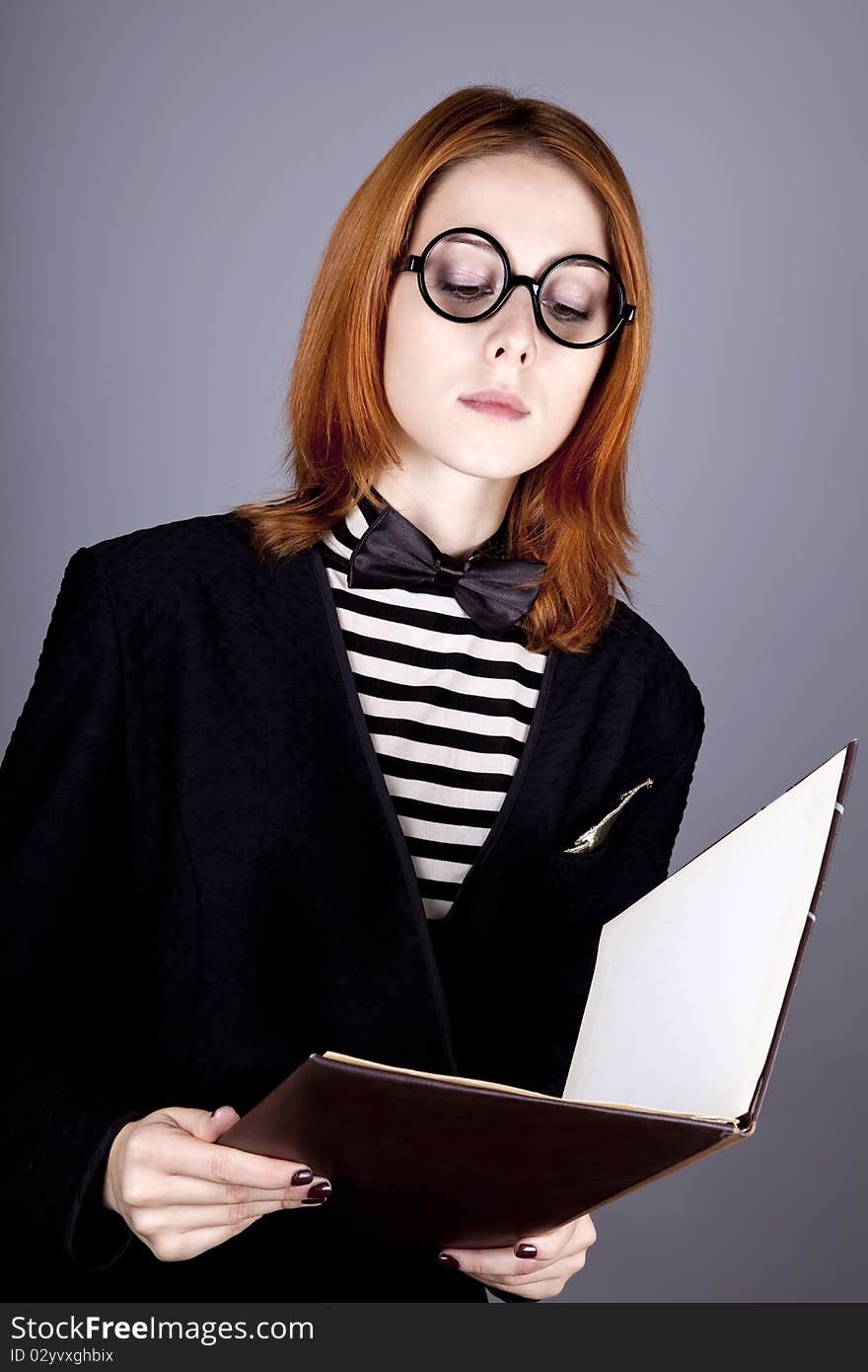 Portrait of beautiful and style red-haired girl with folder. Portrait of beautiful and style red-haired girl with folder.