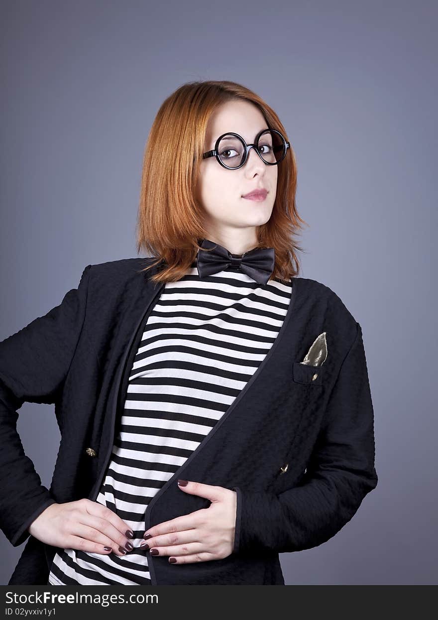 Portrait of beautiful and style red-haired girl. Studio shot.