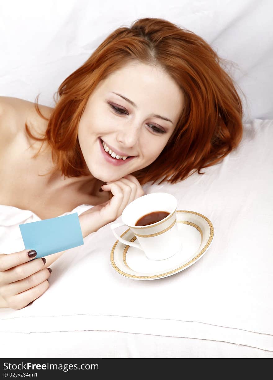 Woman Lying In The Bed Near Cup Of Coffee.