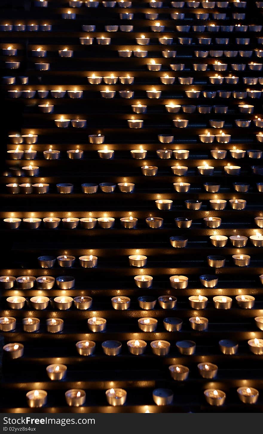 Background of burning candles in a church.