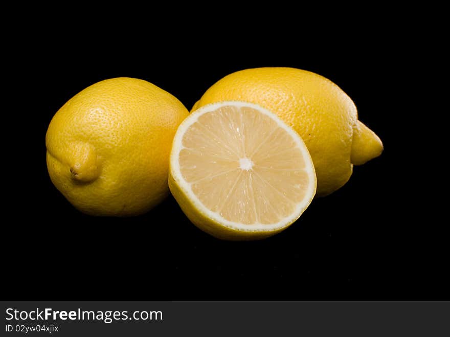 On a black background lie lemons