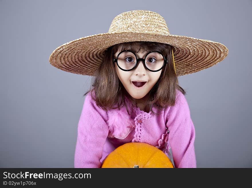 Funny Girl In Cap And Glasses Keeping Pumpkin.