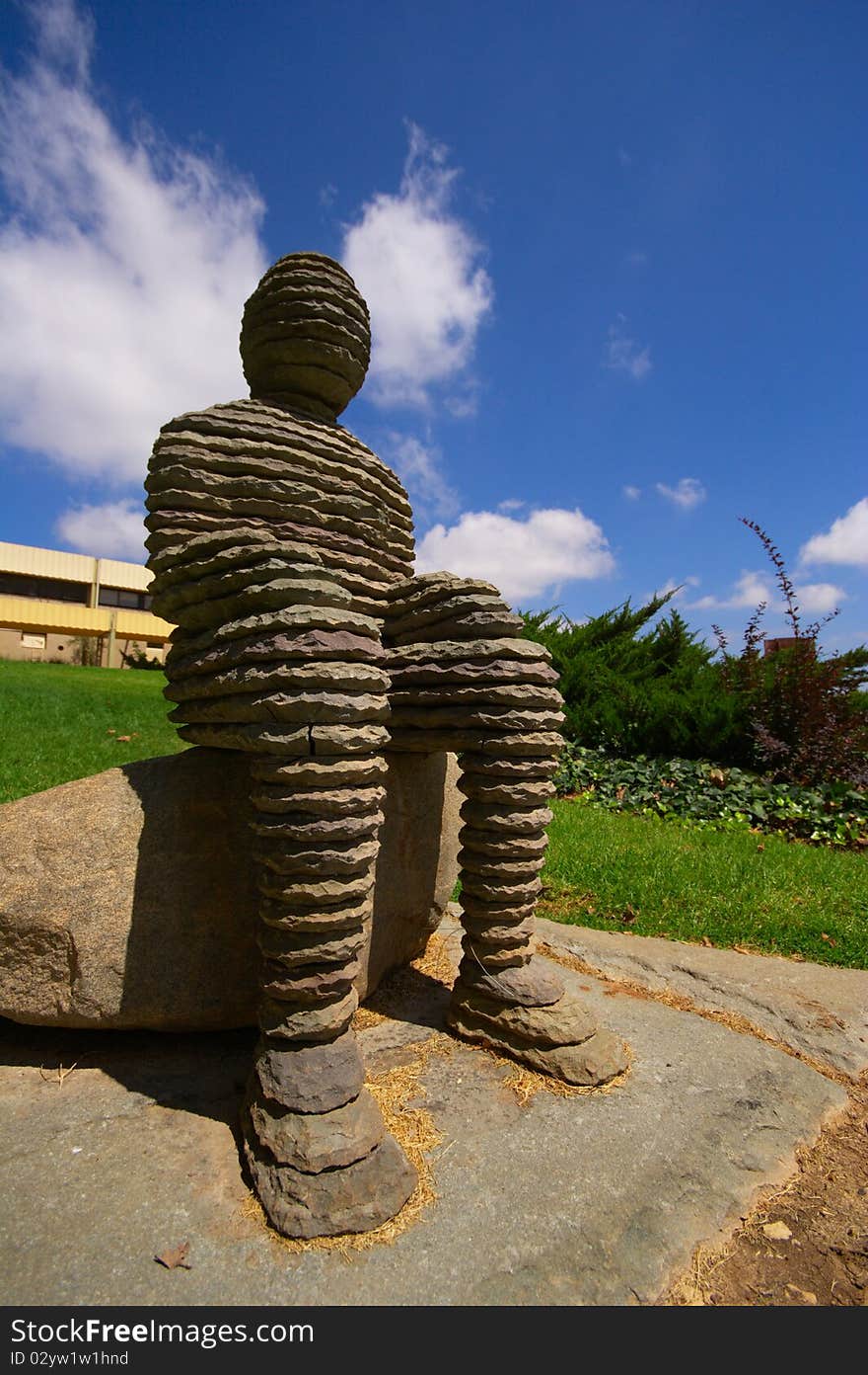 An artists sculpture of a man in a open air museum. An artists sculpture of a man in a open air museum