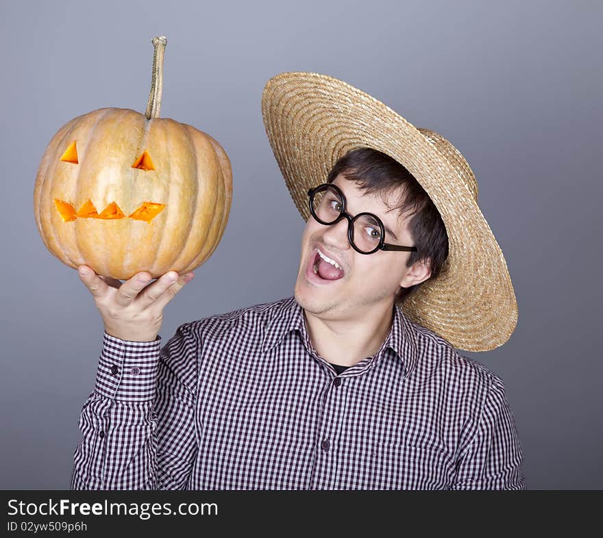 Funny men try to eat a pumpkin. Studio shot.