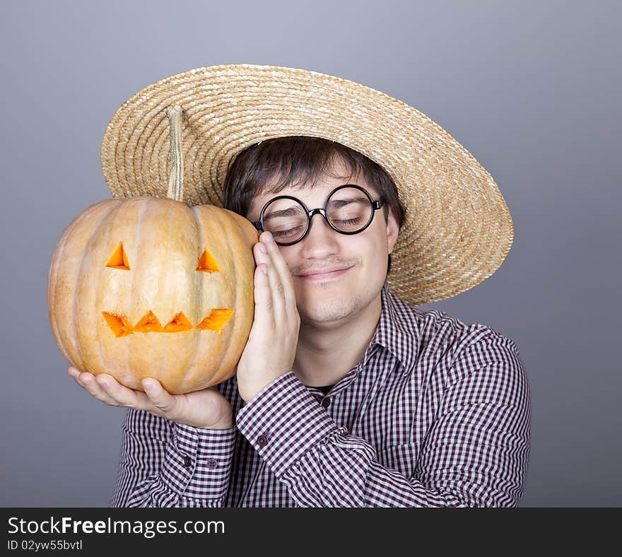 Funny men try to eat a pumpkin. Studio shot.