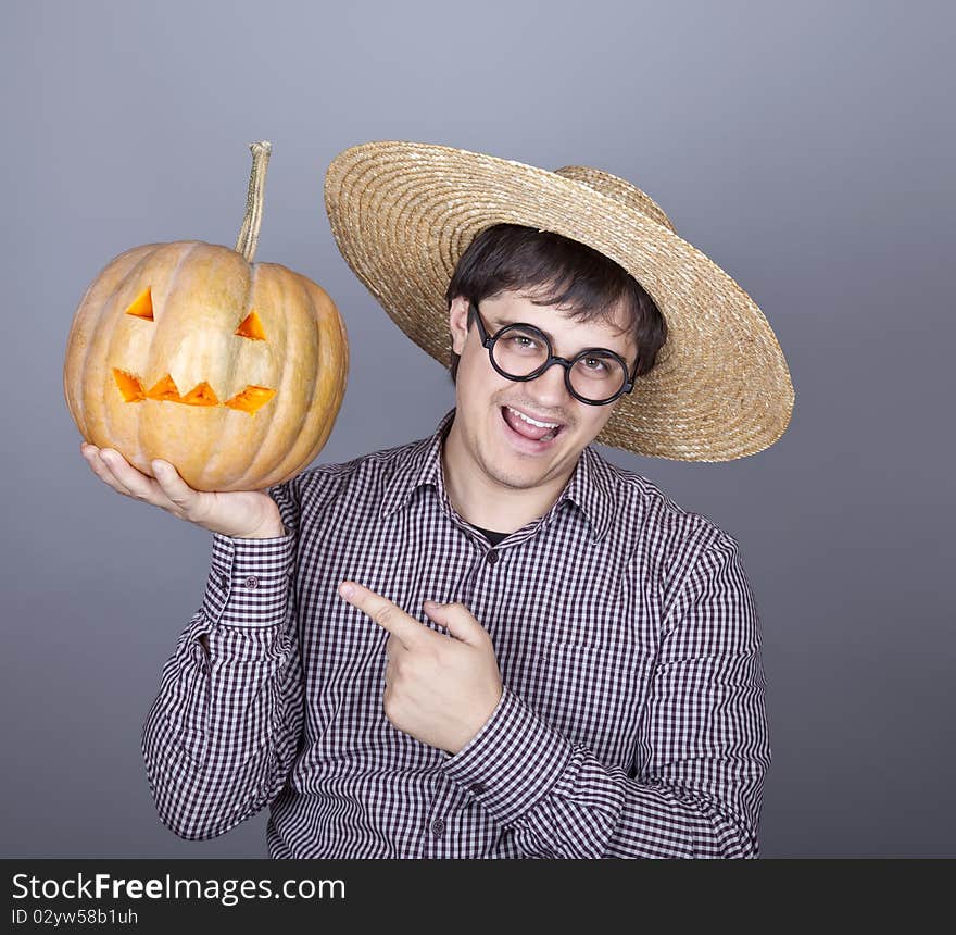 Funny men try to eat a pumpkin. Studio shot.