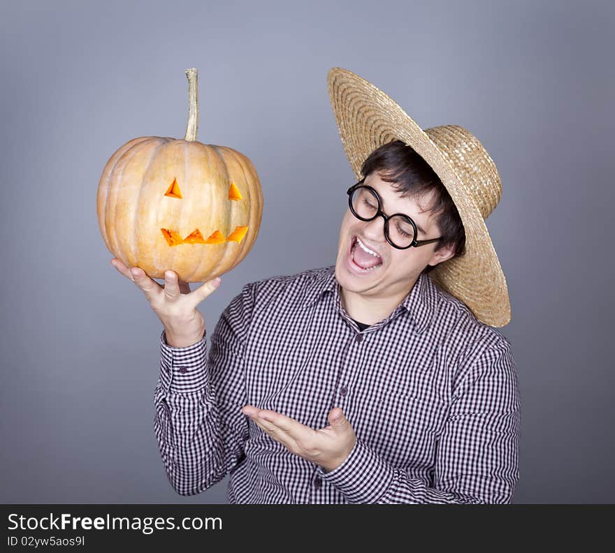 Funny men try to eat a pumpkin. Studio shot.